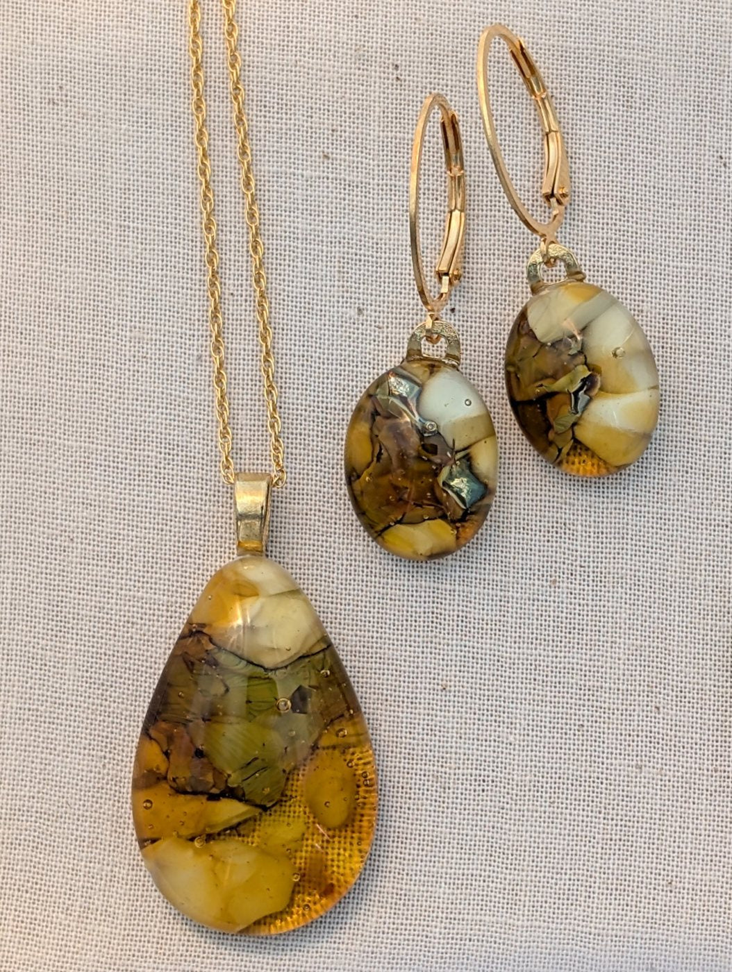 Amber fused glass teardrop pendant and earrings, gold-finished