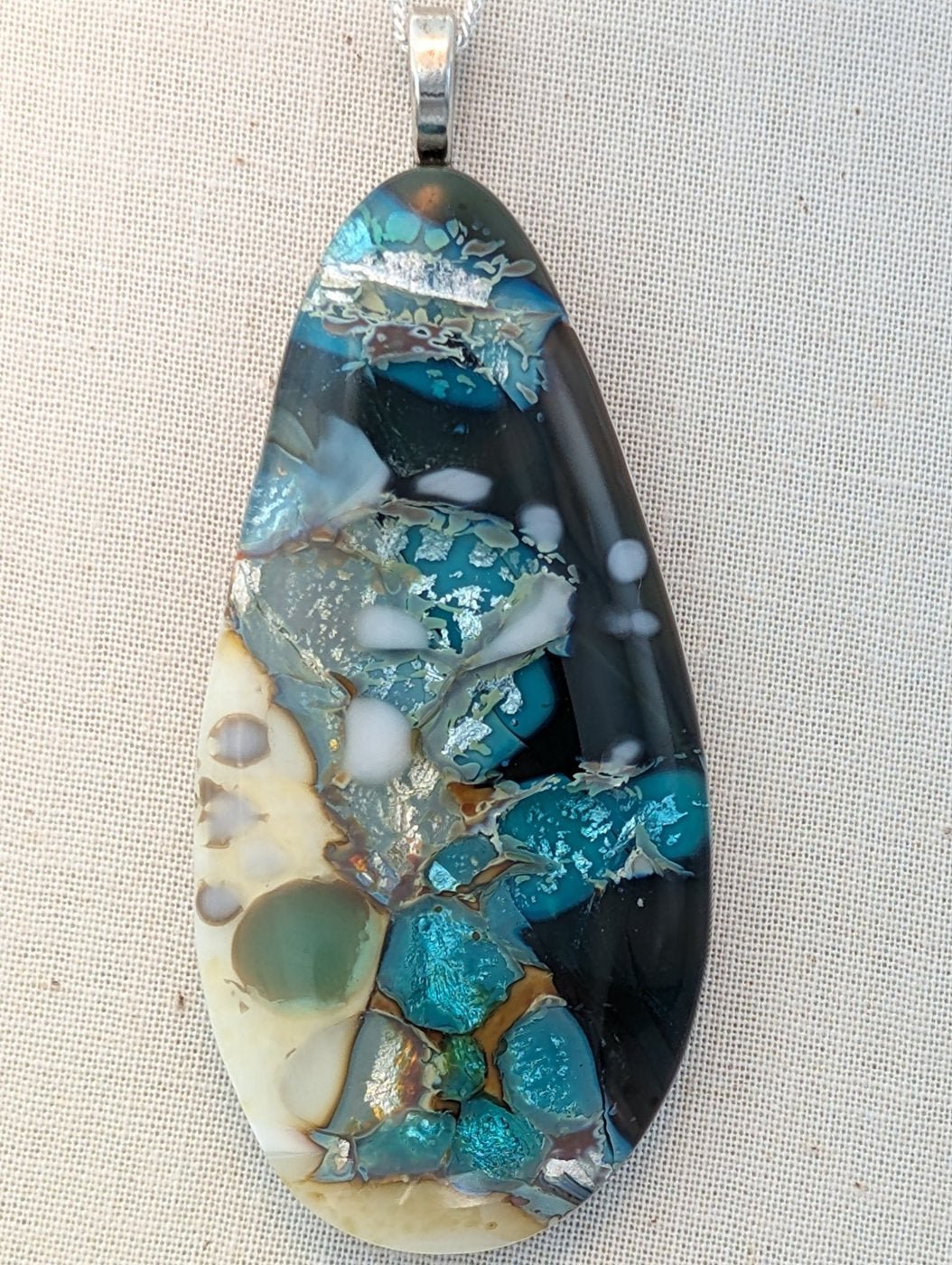 Large fused glass pendant in teal, ivory and charcoal