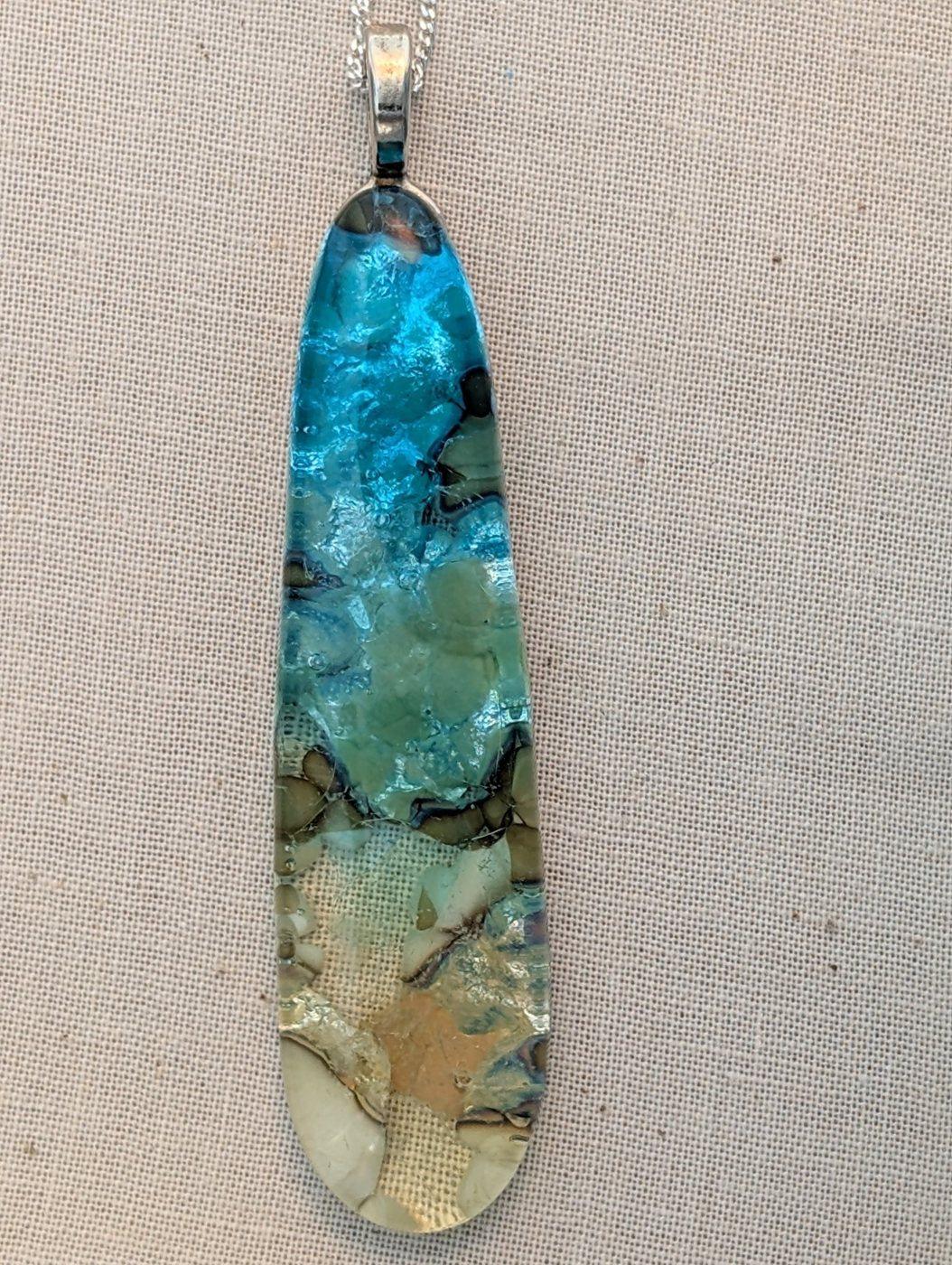 Long fused glass teardrop pendant, blue fading to sand