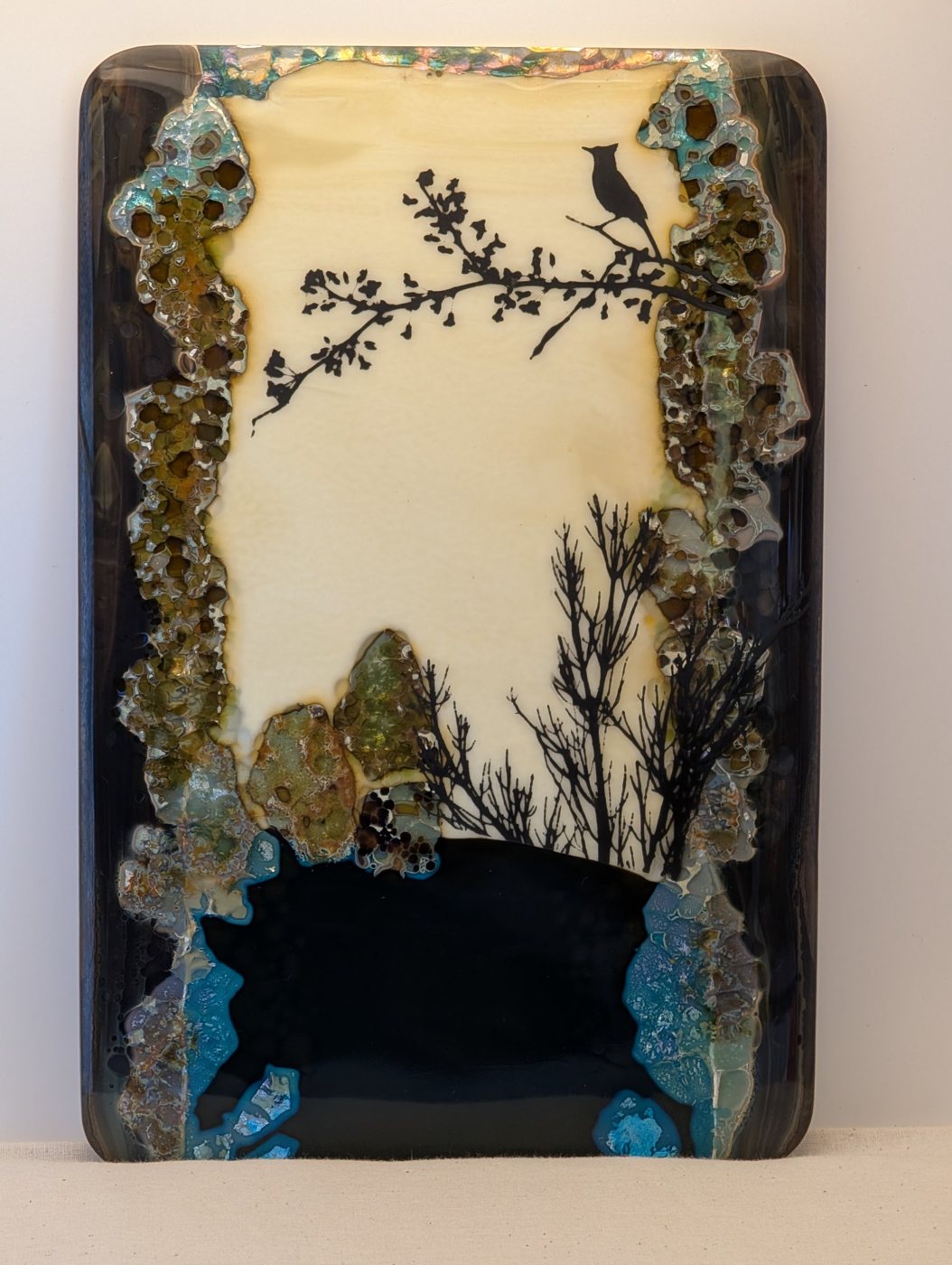 Dusk Song, a fused glass panel with a bird on a branch