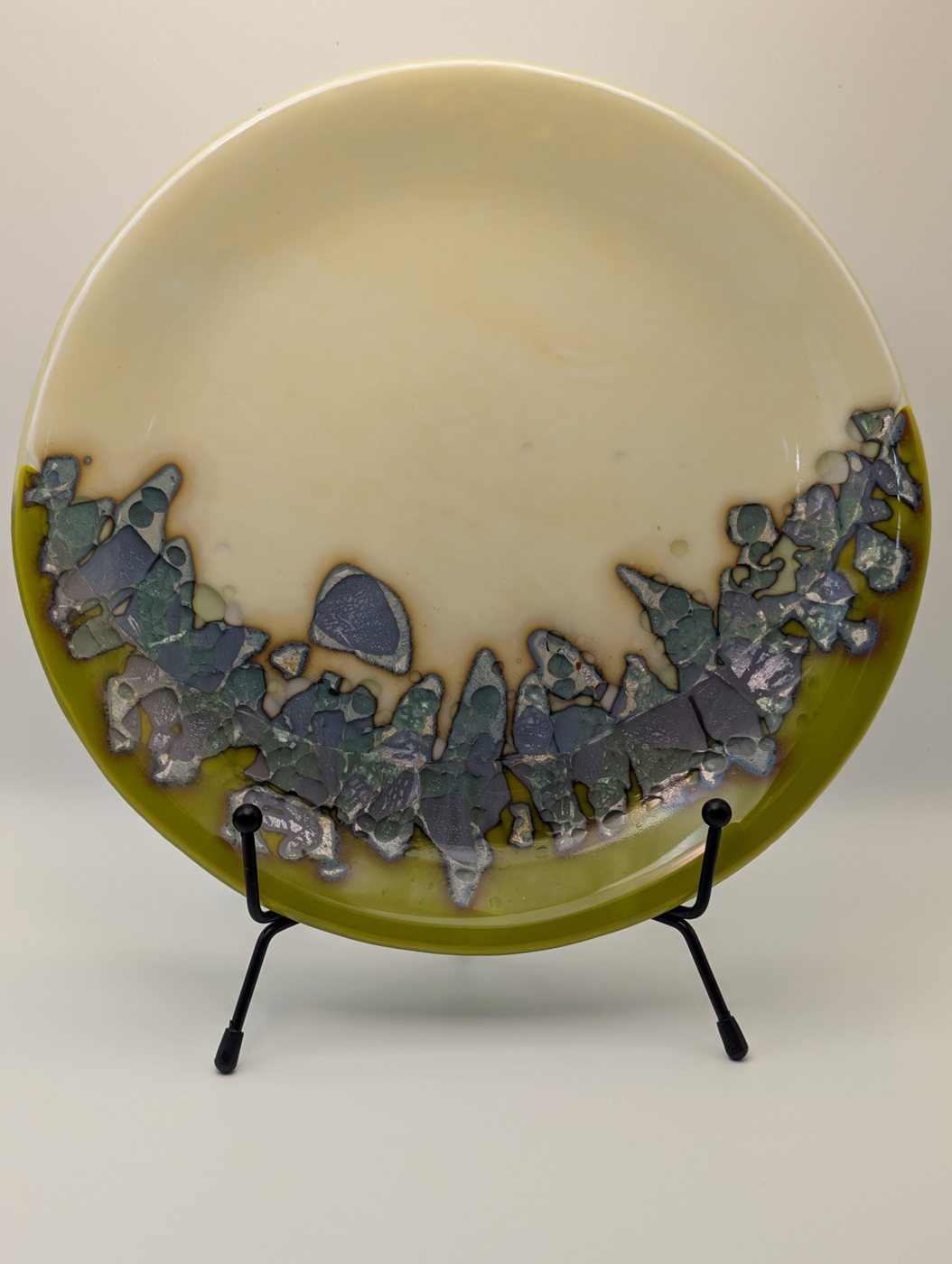 Ivory and olive fused glass plate on a stand